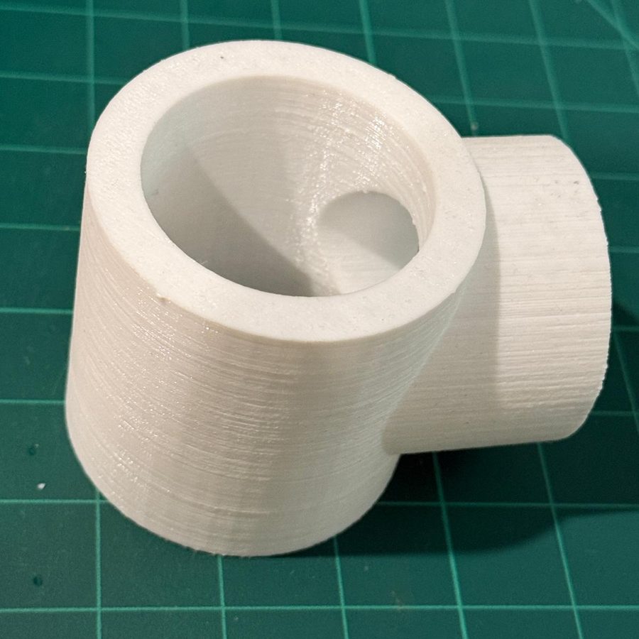 White cylindrical motor housing for a hobby robot, open at one end, with a smaller cylindrical boss projecting from one side